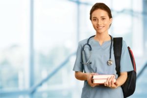 A nurse holding books going to work.