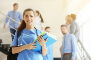 nursing student walking downstairs with peers behind her