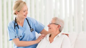 a female cna nurse comforting an elderly female senior