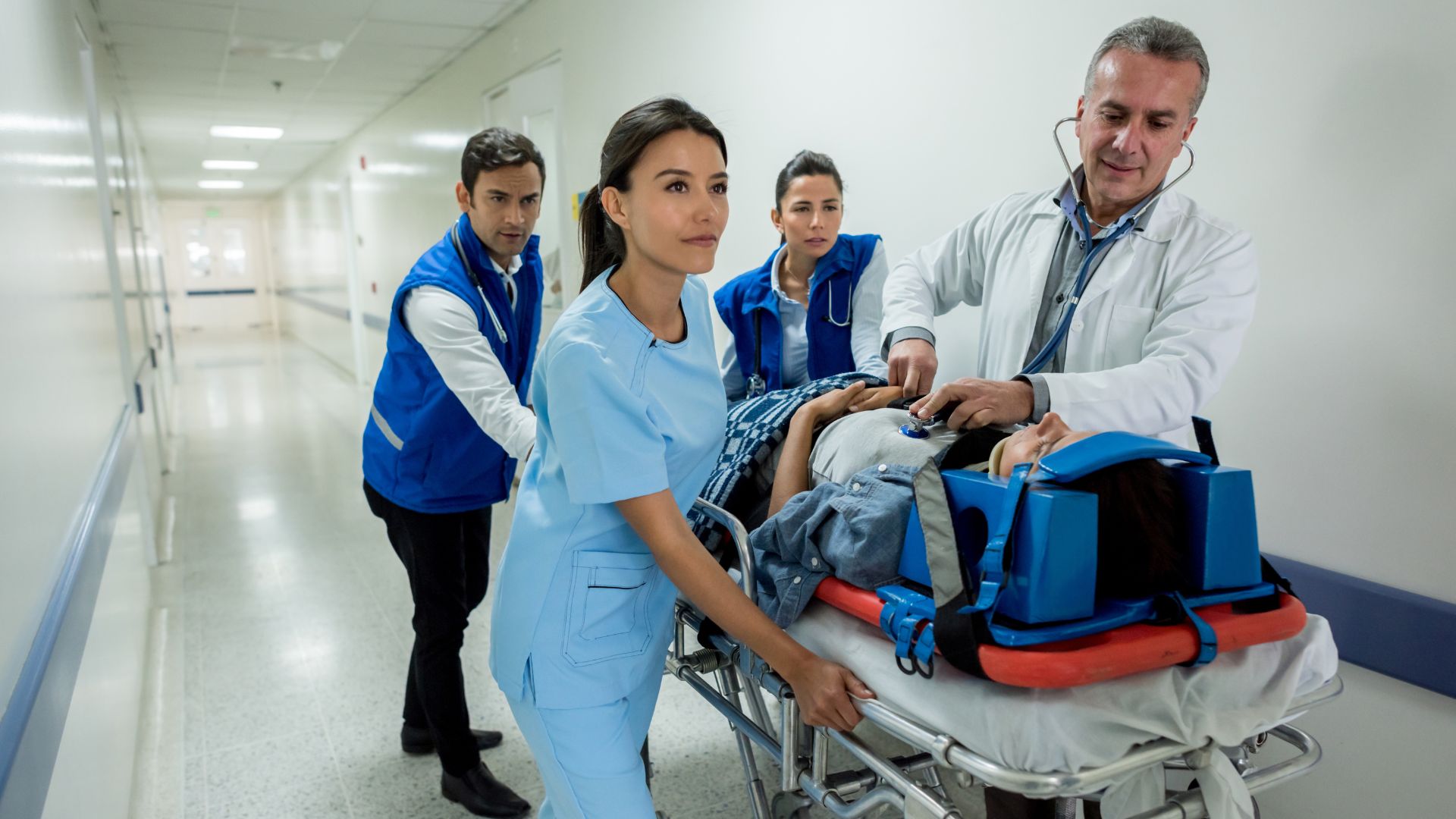 one of nursing specialties showing a critical care nurse transporting a patient in the hospital with a doctor and two other nurses