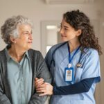 Nurse walking with old woman arm around her arm