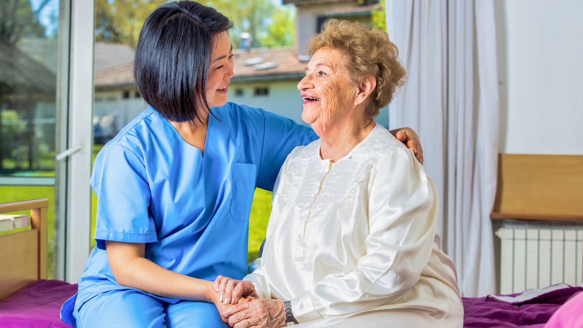 A nurse with her patient in the patient's home, exemplifies how it's possible to find travel nurse jobs as an RN.