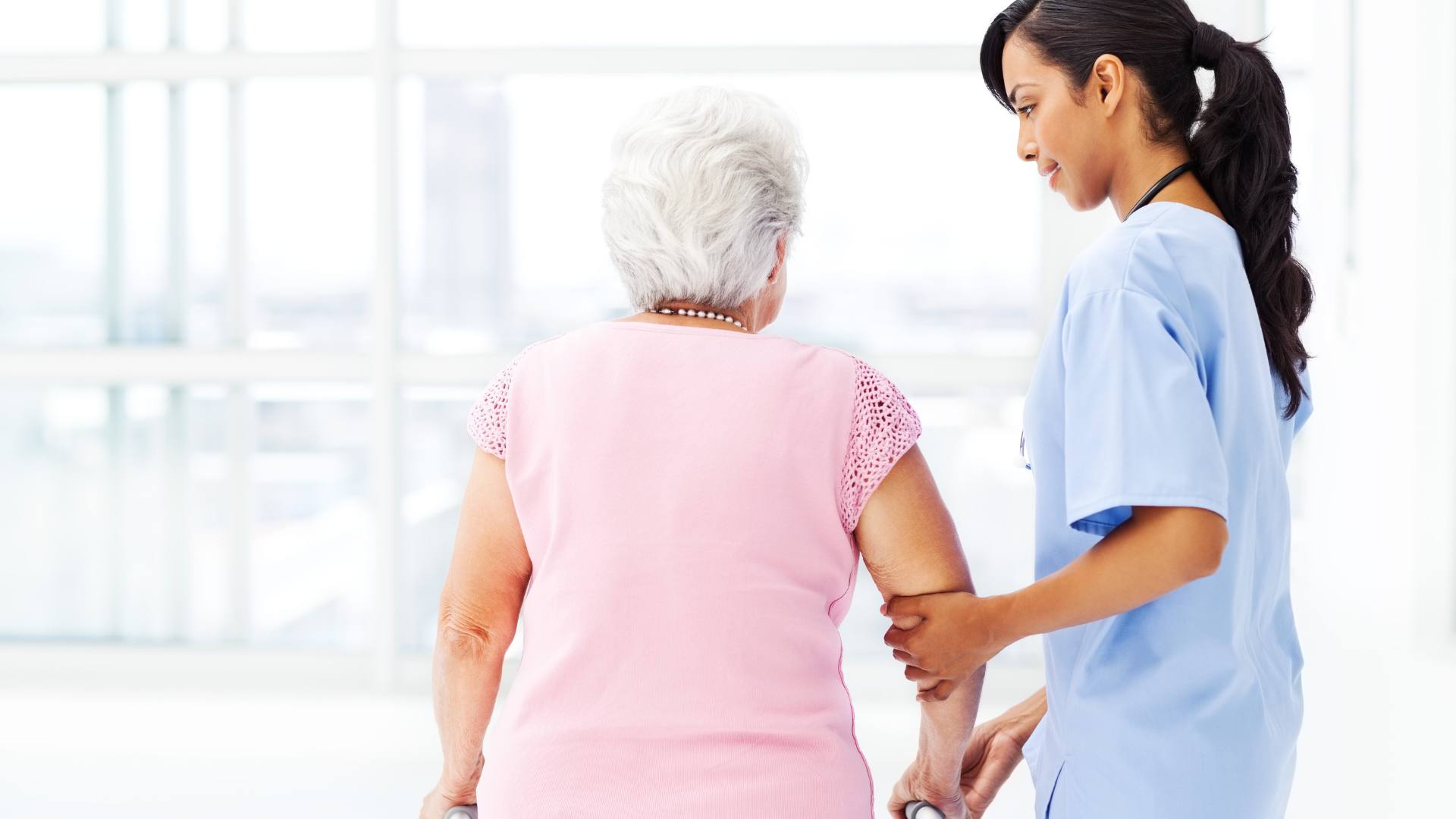 A heartwarming image of an LPN helping an elderly patient in a nursing home. This image demonstrates the importance of nursing home jobs for LPNs.