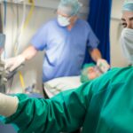 A nurse anesthetist wears a mask in the surgery room during work.
