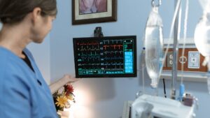 A nurse is monitoring vitals of a patient, demonstrating the LPN role.